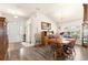 Inviting dining room with wood floors, large windows, chandelier, and front door view at 1 Diamond Cove Pl, Ocala, FL 34472