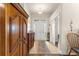 Bright foyer with a dark wood armoire, tile floors, and natural light filling the entry at 1 Diamond Cove Pl, Ocala, FL 34472