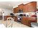 Well-equipped kitchen featuring stainless steel appliances, granite countertops, and dark wood cabinetry at 1 Diamond Cove Pl, Ocala, FL 34472