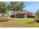 Expansive backyard showcasing lush lawn, screened-in porch, and mature landscaping, perfect for outdoor enjoyment at 10003 Sw 90Th Loop, Ocala, FL 34481