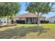 Spacious backyard showcasing lush lawn and screened-in porch, perfect for outdoor relaxation at 10003 Sw 90Th Loop, Ocala, FL 34481