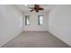 This bright bedroom features carpet flooring, a ceiling fan and two windows for natural light at 10003 Sw 90Th Loop, Ocala, FL 34481