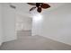 This bright bedroom features carpet flooring, a ceiling fan, and neutral colors at 10003 Sw 90Th Loop, Ocala, FL 34481