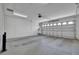 Spacious garage with concrete floor and an automatic door with overhead lighting at 10003 Sw 90Th Loop, Ocala, FL 34481