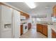 Well-lit kitchen features matching appliances, tile floors, wooden cabinets, and a cozy breakfast nook at 10003 Sw 90Th Loop, Ocala, FL 34481