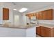 Bright kitchen with tile floors, plentiful cabinet space, white appliances, and breakfast bar area at 10003 Sw 90Th Loop, Ocala, FL 34481