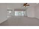 A view of a spacious living room, with expansive glass doors, that brings an abundance of natural light at 10003 Sw 90Th Loop, Ocala, FL 34481