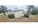 Rear exterior of this one-story home, with mature landscaping and traditional shutters at 10060 Sw 93Rd Ave, Ocala, FL 34481