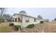 A cozy exterior of this one-story home with traditional shutters, mature landscaping, and side yard at 10060 Sw 93Rd Ave, Ocala, FL 34481