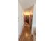 Hallway view with laminate flooring and neutral paint leading to the living room at 10060 Sw 93Rd Ave, Ocala, FL 34481