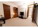 Bedroom with neutral carpet, a wooden bookcase, and a view of the tiled bathroom at 10498 Sw 99Th Ave, Ocala, FL 34481