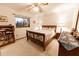 Cozy bedroom with a wooden sleigh bed, ceiling fan, and neutral carpet at 10498 Sw 99Th Ave, Ocala, FL 34481