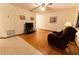 Cozy living room features wood floors, neutral walls, ceiling fan and nice natural lighting at 10498 Sw 99Th Ave, Ocala, FL 34481