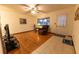 Living room featuring wood floors, neutral walls, natural lighting and a ceiling fan at 10498 Sw 99Th Ave, Ocala, FL 34481