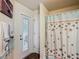 Bathroom featuring a shower, a vanity, and an exterior door at 1083 Se 65Th Cir, Ocala, FL 34472