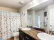 Bathroom with double vanity and shower with starfish curtain at 1083 Se 65Th Cir, Ocala, FL 34472