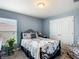 Cozy bedroom with a full size bed, light blue walls and large closet at 1083 Se 65Th Cir, Ocala, FL 34472