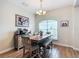 Bright dining room featuring wood floors, decorative chandelier, and a large window at 1083 Se 65Th Cir, Ocala, FL 34472