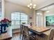 Dining room features wood floors, pendant lighting, and a large window at 1083 Se 65Th Cir, Ocala, FL 34472