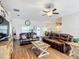 Living room featuring wood floors, ceiling fan, and ample seating at 1083 Se 65Th Cir, Ocala, FL 34472