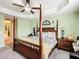 Spacious main bedroom with a four-poster bed, carpet flooring, and a ceiling fan at 1083 Se 65Th Cir, Ocala, FL 34472