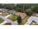 An aerial view of a well-maintained home with a spacious backyard and mature landscaping in a quiet neighborhood at 10884 Sw 53Rd Cir, Ocala, FL 34476