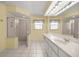 Spacious bathroom featuring a large vanity, a shower stall, and bright lighting at 10884 Sw 53Rd Cir, Ocala, FL 34476