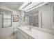 Bathroom featuring a large vanity, framed window, and glass shower at 10884 Sw 53Rd Cir, Ocala, FL 34476