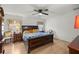 Spacious bedroom with ceiling fan and a large dark wood bed at 10884 Sw 53Rd Cir, Ocala, FL 34476