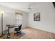 Bright bedroom with desk, ceiling fan and wood-look flooring at 10884 Sw 53Rd Cir, Ocala, FL 34476