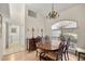 Dining room showcasing a wooden table, chandelier lighting, and window with blind at 10884 Sw 53Rd Cir, Ocala, FL 34476