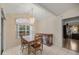 Cozy dining room with tile floors, modern chandelier and window at 10884 Sw 53Rd Cir, Ocala, FL 34476