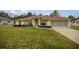 Charming home boasts a spacious front yard, beautiful landscaping, and an inviting entryway with an arched portico at 10884 Sw 53Rd Cir, Ocala, FL 34476