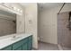 Bathroom with a tiled walk-in shower, sleek vanity, and modern fixtures at 11862 Se 72Nd Terrace Rd, Belleview, FL 34420