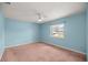 Bright bedroom with a large window, ceiling fan, and pink carpet at 11862 Se 72Nd Terrace Rd, Belleview, FL 34420