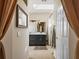 Bathroom with dark vanity, marble countertop, modern lighting and shower at 13096 Se 93Rd Terrace Road, Summerfield, FL 34491