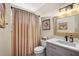 Bathroom featuring a vanity with marble countertop, stylish mirror, and coordinating decor at 13096 Se 93Rd Terrace Road, Summerfield, FL 34491