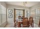 Bright dining room featuring a wood table and chairs, modern lighting, and decorative bird artwork at 13096 Se 93Rd Terrace Road, Summerfield, FL 34491