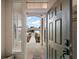 View through the front door showing a walkway with meticulous landscaping and a glimpse of the neighborhood at 13096 Se 93Rd Terrace Road, Summerfield, FL 34491