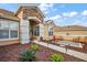 Inviting home exterior featuring lush landscaping, a stone accent wall and a cozy outdoor seating area at 13096 Se 93Rd Terrace Road, Summerfield, FL 34491