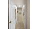 Hallway with neutral tile, art, and doorways, showing seamless transition between rooms at 13096 Se 93Rd Terrace Road, Summerfield, FL 34491