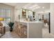 Inviting kitchen pass-through with counter seating, skylight, and view to the dining area at 13096 Se 93Rd Terrace Road, Summerfield, FL 34491