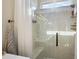 Modern shower features glass doors and a built in bench, providing a spa-like experience at 13096 Se 93Rd Terrace Road, Summerfield, FL 34491