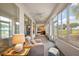 Relaxing sunroom with view to the yard featuring lots of windows and natural light at 13096 Se 93Rd Terrace Road, Summerfield, FL 34491