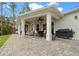 This covered patio features brick pavers, ceiling fans, and an outdoor seating area perfect for entertaining or relaxing at 13105 Sw 73Rd Avenue Rd, Ocala, FL 34473