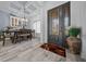 Welcoming dining area featuring a stylish table setting, coffered ceiling, and elegant front doors at 13105 Sw 73Rd Avenue Rd, Ocala, FL 34473