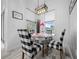 Cozy dining area features modern light fixture, table, and patterned chairs with bright windows at 13105 Sw 73Rd Avenue Rd, Ocala, FL 34473