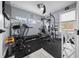 Bright home gym featuring a treadmill, weight rack, large mirror, and multiple windows at 13105 Sw 73Rd Avenue Rd, Ocala, FL 34473