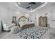 Comfortable main bedroom with wood-look floors, a patterned rug, and accent chair at 13105 Sw 73Rd Avenue Rd, Ocala, FL 34473