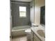 Bathroom with tiled shower, tub, and updated fixtures at 15 Clear Way, Ocala, FL 34472